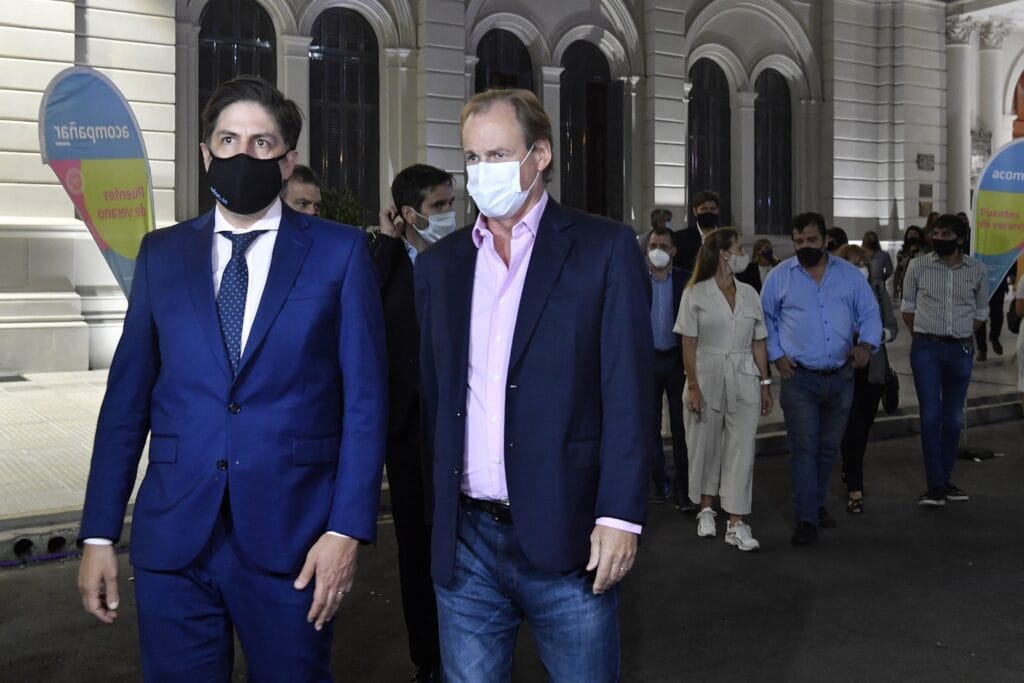 alt="Bordet y Trotta caminan frente a la casa de gobierno en Paraná"