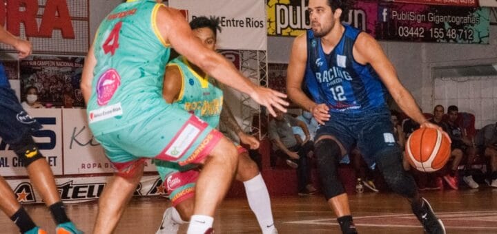 alt="un jugador de básquet pica el balón frente a dos rivales"