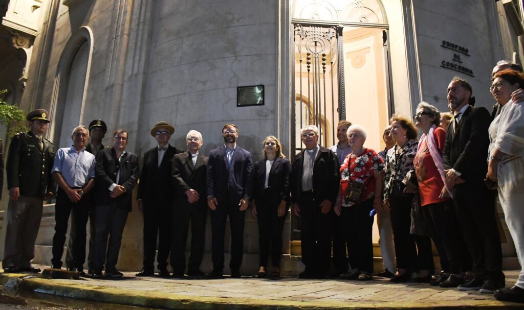 alt="el intendente, funcionarios municipales, concejales, el presidente de la Asociación Art Nouveau de Buenos Aires y otras autoridades en el edificio del Obispado de Concorrdia durante la ceremonia oficial de nombramiento de Ciudad Art Nouveau de América 2025"