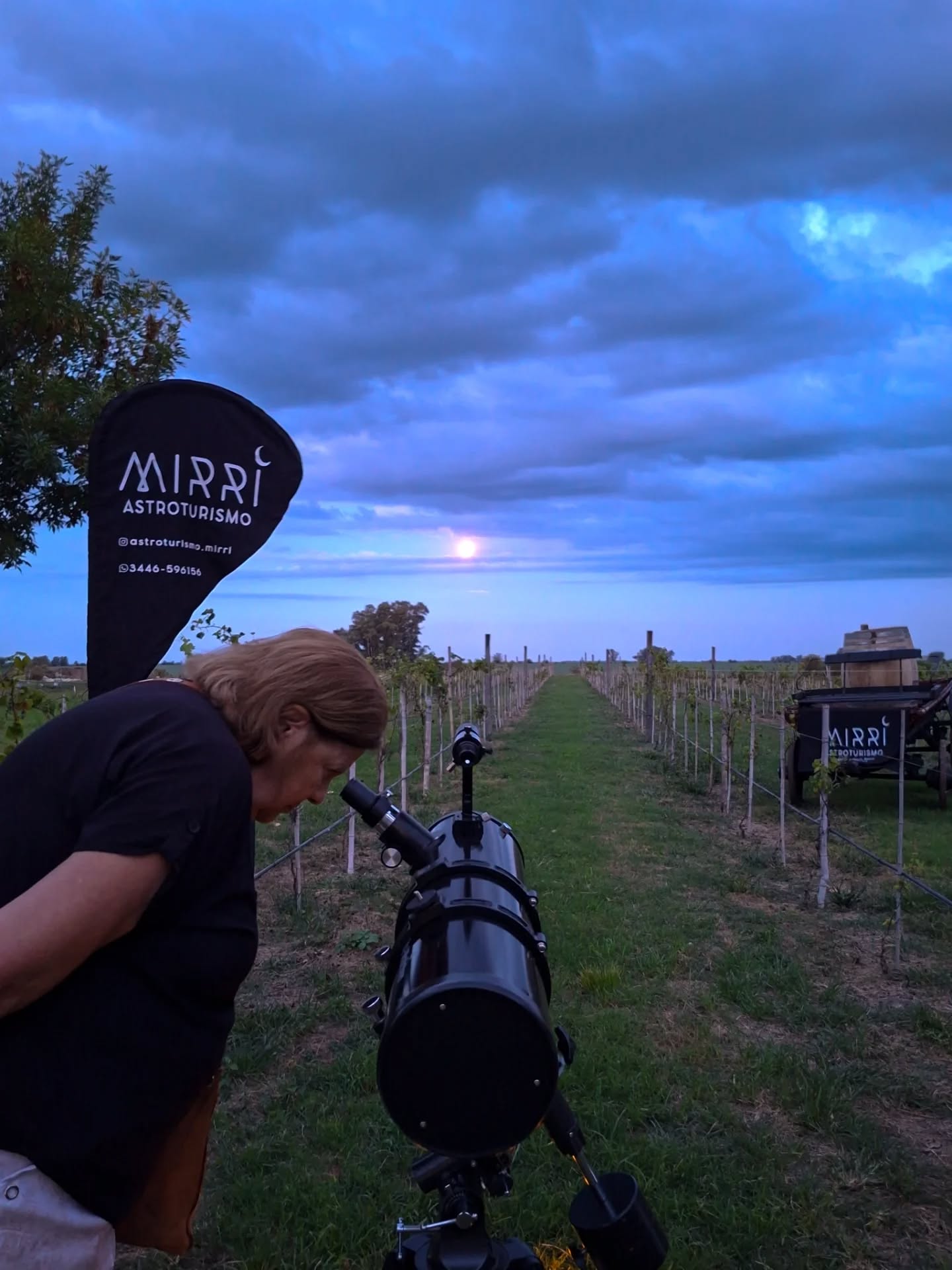 alt="Telescopio frente a viñedos bajo la luna llena para la actividad de astroturismo y enoturismo sustentable en Bodega Cinco Ceibos en Entre Ríos"